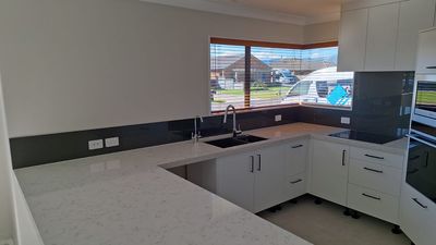 Black glass splashback in a kitchen