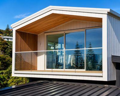 Glass balustrade on a gable balcony with a timber soffit