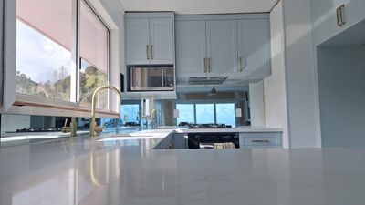 Custom mirror splashback in a kitchen