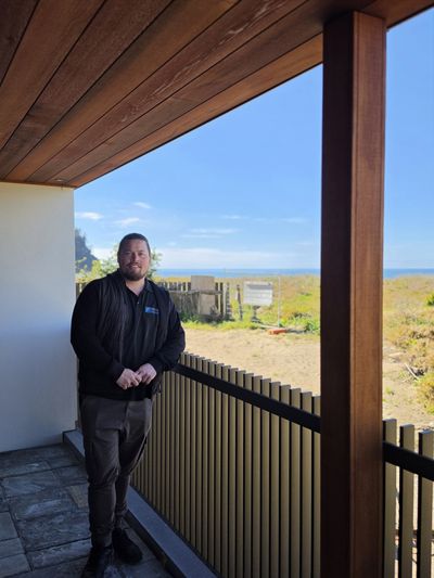 Postless architectural aluminium balustrade on a balcony with a coastal view, Whangamata