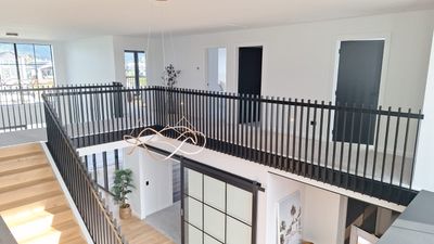 Postless architectural aluminium balustrade on an upper landing, Whitianga