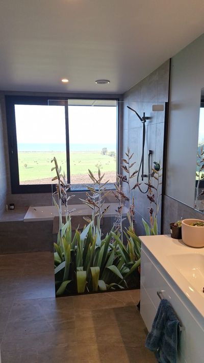 Printed frameless shower screen with a flax design